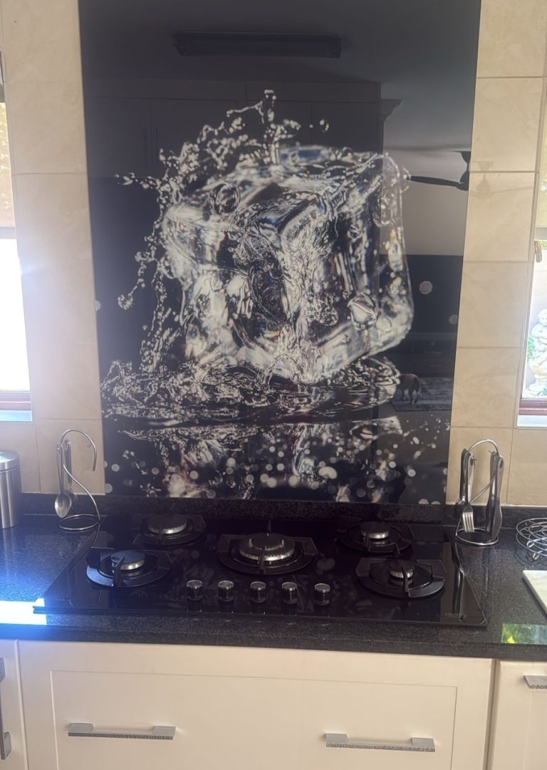 Custom-made glass splashback designed to hide damaged tiles and create a fresh finish