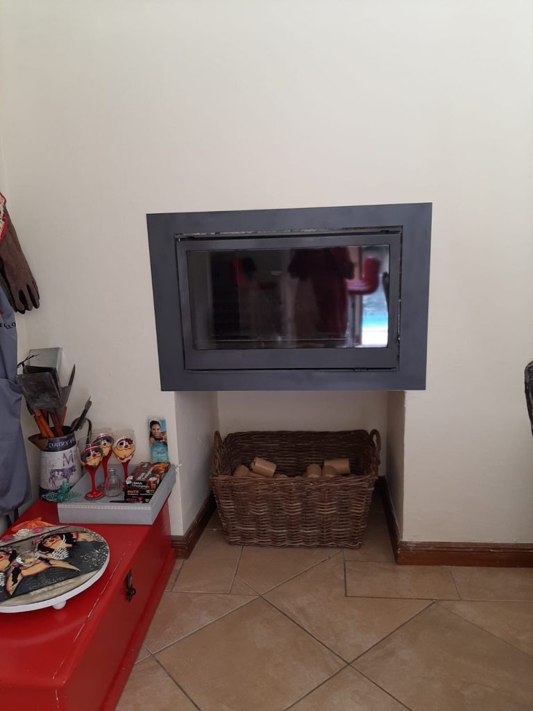 Wall with built-in fireplace before the redesign