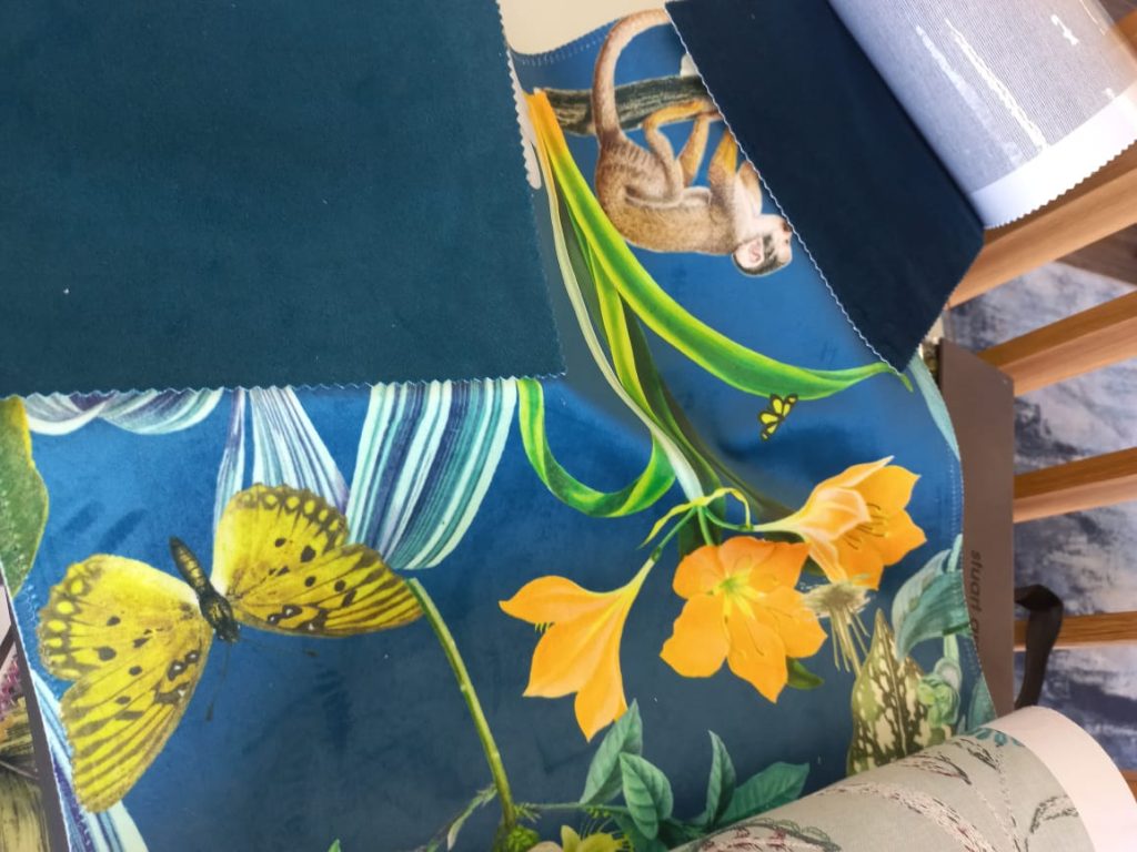 Blue botanical fabric with butterflies, flowers and monkey print with darker blue velvet