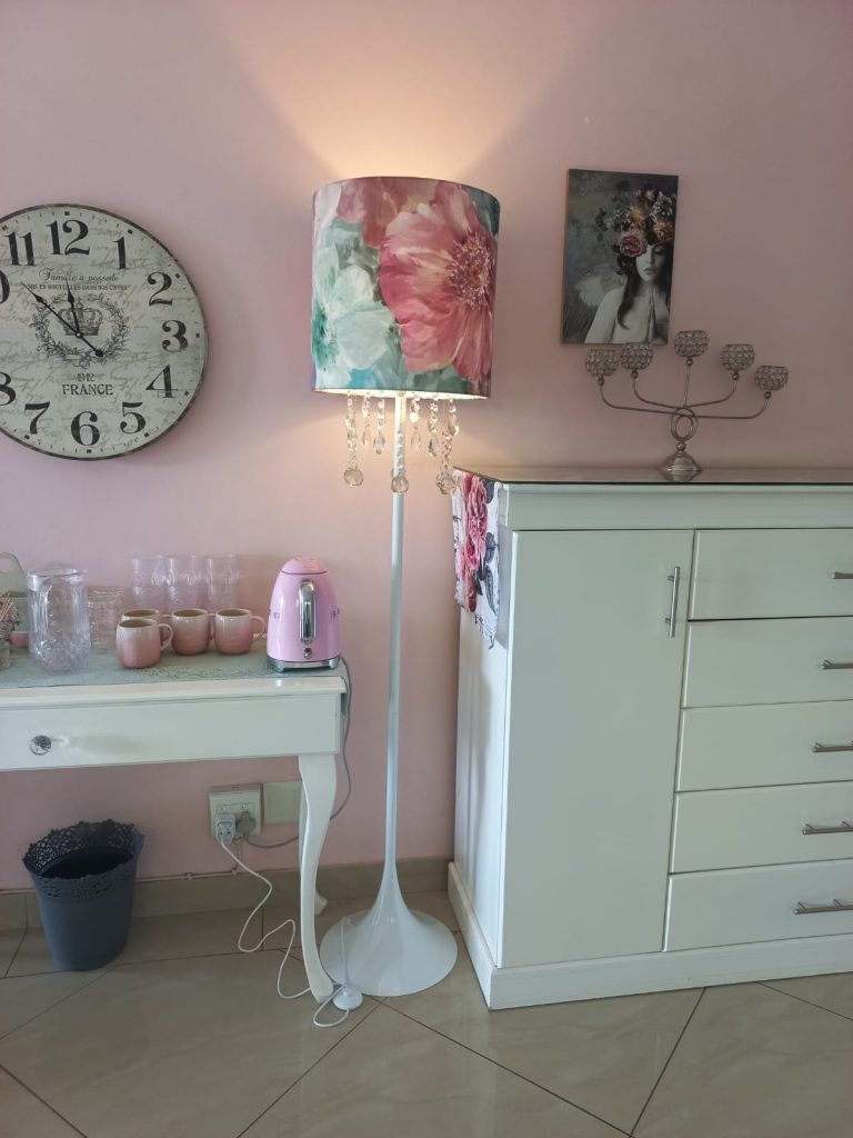 Crystal lamp in place with pink and aqua fabric tying the room colours together