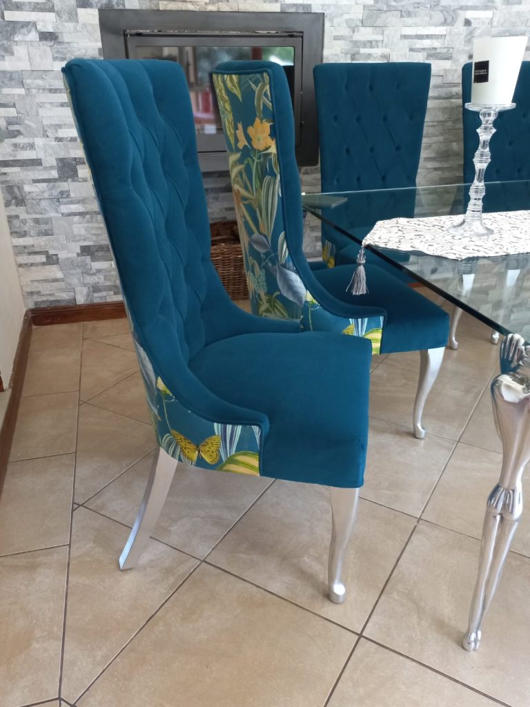Dining chair upholstered in vibrant blue velvet and botanical monkey and butterfly velvet print