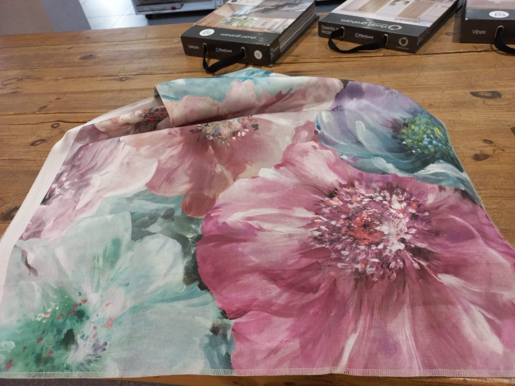 Pink and aqua floral fabric selected to tie together the colours of the room